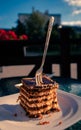 Vertical shot of a fork in the slice of a delicious chocolate cake Royalty Free Stock Photo