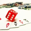 Vertical shot of four aces, a dice, and gambling chips Royalty Free Stock Photo