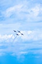 Vertical shot of four airplanes flying in the cloudy blue sky