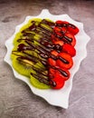 Vertical shot of fresh kiwi and strawberry decorated with chocolate