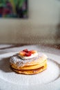 Vertical shot of fresh pancakes with strawberries, cream, and sugar powder Royalty Free Stock Photo