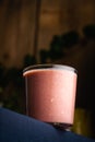 Vertical shot of a fresh strawberry smoothie in a simple glass cup
