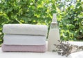 Vertical shot.Fresh washed soft towels.Bottle of lavebder softener and clean towels outdoor