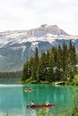 Vertical shot of the freshwater Emerald Lake and red canoes in Yoho National Park Banff Canada