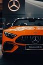 Vertical shot of the front side of the luxury Mercedes-Benz AMG SL against blur background
