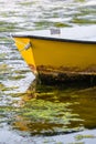 Vertical shot of the front yellow detail of a boat on the water