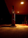 Vertical shot of a fuel dispenser at an empty gas station at night Royalty Free Stock Photo