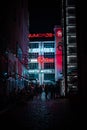 Vertical shot of Galeria Neon Side at night with people outdoor in Poland,Wroclaw