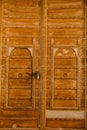 Vertical shot of a gate with two round knockers and a latch, in Mandawa haveli in Rajasthan India