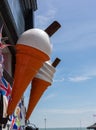 Vertical shot of giant plastic ice cream cone signs in Broadstairs