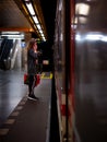 Vertical shot of a girl in a mask waiting for a metro in the subway station in Prague. Royalty Free Stock Photo