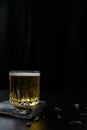 Vertical shot of a glass of alcoholic or non-alcoholic beer standing on black wooden table Royalty Free Stock Photo