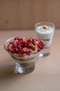 Vertical shot of a glass bowl of vanilla yogurt with currants on top on a beige background