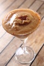 Vertical shot of a glass of Chocolate Daiquiri on a wooden table with a blurry background