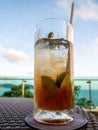 Vertical shot of a glass of iced drink with lime slices and a straw on the table Royalty Free Stock Photo