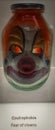 Vertical shot of a glass jar with clown face - coulrophobia concept