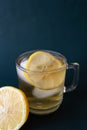 Vertical shot of a glass of lemon iced tea on dark background Royalty Free Stock Photo