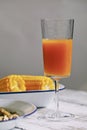 Vertical shot of a glass of mango juice on the table