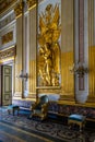 Vertical shot of gold decorations on the walls in the Royal Palace of Caserta, Campania