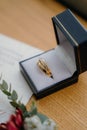 Vertical shot of golden bridal rings in a box