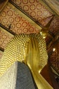 Vertical shot of the golden Reclining Buddha statue's hand in the Wat Pho temple Royalty Free Stock Photo