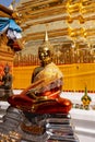 Vertical shot of a golden statue of Buddha in a temple