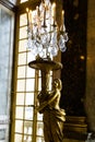 Vertical shot of a golden statue in the Hall of Mirrors in Versailles Palace in France Royalty Free Stock Photo