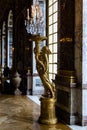 Vertical shot of a golden statue in the Hall of Mirrors in Versailles Palace in France Royalty Free Stock Photo