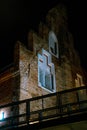 Vertical shot of gothic-styled windows on a brick wall