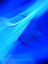 Vertical shot of gradual rhythmic light trails on a blue background