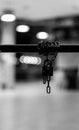 Vertical shot of grayscale chain holding with lock with blur background