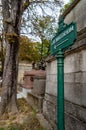 Vertical shot of a green board reading 'Crematorium' in the Pere Lachaise Cemetery in Paris, France