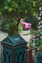 Vertical shot of a green ornamented garbage disposal can in the street Royalty Free Stock Photo