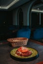 Vertical shot of a green plate with a beautifully served meat dish