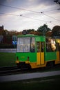 Vertical shot of green and yellow public transport tram in the Zawady area at sunset Royalty Free Stock Photo
