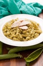 Vertical shot of grilled chicken and spiral pasta with fresh organic peas