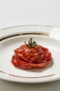 Vertical shot of grilled and smashed tomato on a plate