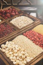 Vertical shot of a grocery wooden storage full of nuts and grains