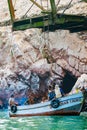 Vertical shot of a group of men employed in the extraction of guano in the Ballestas islands