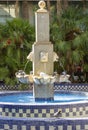 Vertical shot of a group of pigeons drinking water on a fountain on a hot summer day