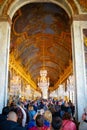 Vertical shot of the Hall of Mirrors at Versailles Palace in Paris, France packed with tourists