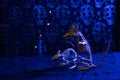 Vertical shot of Halloween rats figurines against a grungy skull wall with bluelights background