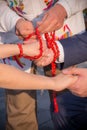 Vertical shot of handfasting ceremony using a red beaded cord Royalty Free Stock Photo