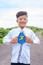 vertical shot of Happy kid showing super power by removing shirt buttom - concept of fantasy, Halloween and inspiration Royalty Free Stock Photo