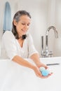Vertical shot of a happy smiling attractive senior woman morning routine with salt soap aroma balls Royalty Free Stock Photo