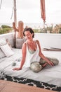 Vertical shot of a happy woman resting comfortably on the mattress at home Royalty Free Stock Photo