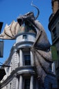 Vertical shot of a Harry Potter theme building with a big dragon on top in Universal Studios