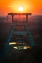Vertical shot of a headframe tower with a golden sun setting in the background in Herten, Germany Royalty Free Stock Photo