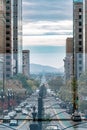 Vertical shot of high urban buildings by the road