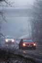 Vertical shot of a highway with cars driving on a foggy winter day